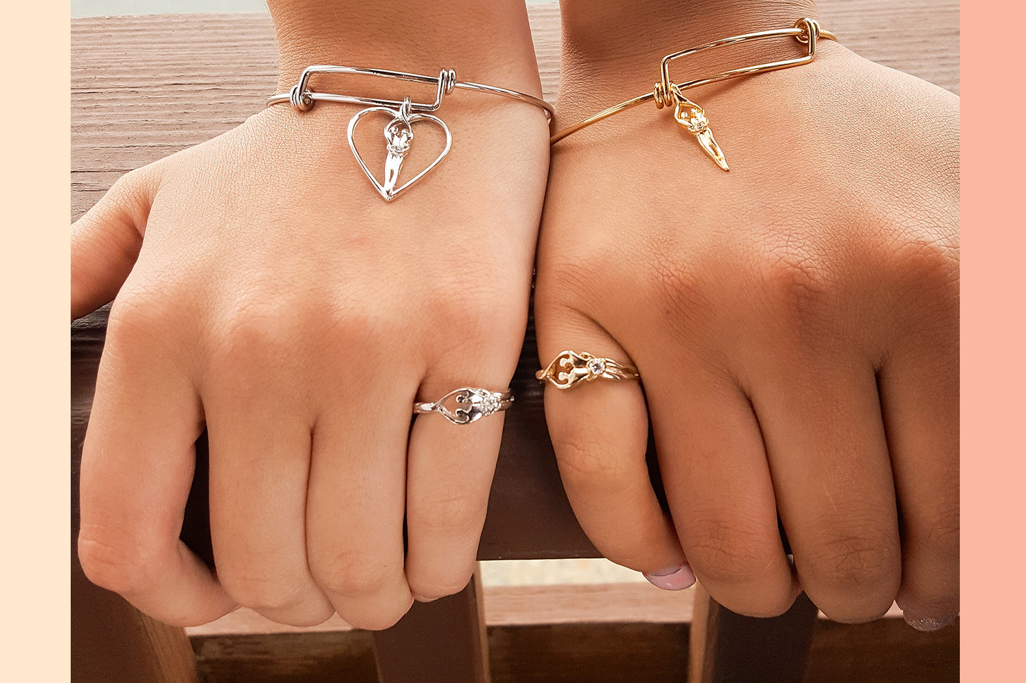 Two hands modeling soulmate collection jewelry